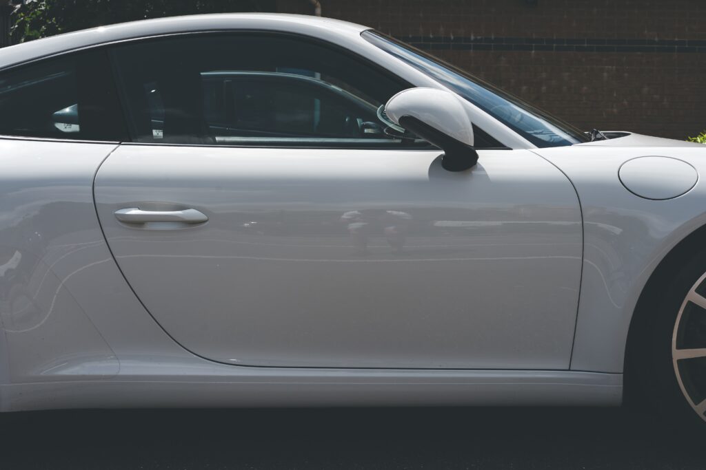 Side profile of a white porsche with no hail dents