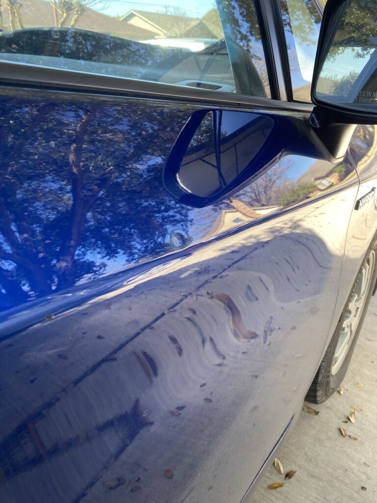 door dings on a blue 2010 toyota prius about to be removed using Fort Worth paintless dent removal